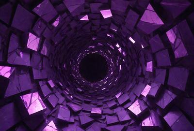 The primary subject of the image is a large, purple tunnel with a black hole in the center. The tunnel is surrounded by a purple and black pattern, giving it a unique and visually striking appearance. The setting is a dark, enclosed space, and the visual style is a combination of digital art and illustration. The dominant colors in the image are purple and black, creating a moody and mysterious atmosphere.