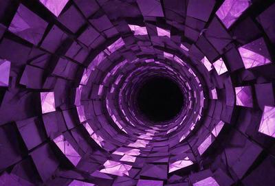 The primary subject of the image is a purple tunnel or hole, which appears to be a part of a larger structure. The setting is a dark environment, possibly a cave or an underground space. The visual style of the image is a combination of digital art and illustration, creating a unique and intriguing appearance. The dominant colors in the image are purple and black, giving the scene a mysterious and captivating atmosphere.