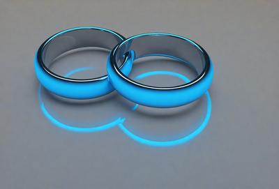 The primary subject of the image is a pair of blue rings. The setting is a gray background, which creates a contrast with the rings. The visual style is a digital art, as the rings appear to be glowing and have a blue hue. The colors and mood of the image are predominantly blue, giving it a cool and modern appearance.