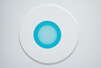 The primary subject of the image is a blue circle with a white background. The circle appears to be a piece of art or a decorative element, possibly a part of a larger design. The setting is a white surface, which provides a clean and minimalist backdrop for the blue circle. The visual style of the image is a combination of artistic and digital elements, creating a unique and eye-catching design. The colors and mood of the image are predominantly blue and white, giving it a calm and serene atmosphere.