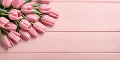 The primary subject of the image is a bouquet of pink tulips. The setting is a pink wooden surface, which serves as the background. The visual style is a close-up of the flowers, showcasing their beauty. The colors and mood of the image are predominantly pink, creating a warm and inviting atmosphere.