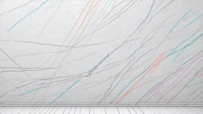 The primary subject of the image is a marble wall with a pattern of blue, orange, and green stripes. The setting is a room with a white floor, and the visual style is a close-up of the marble wall. The colors and mood of the image are vibrant and lively, with the blue, orange, and green stripes creating a visually striking pattern on the marble surface.