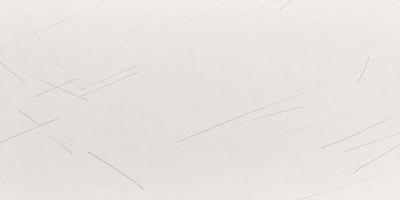 The primary subject of the image is a white sheet of paper with a pattern of black lines or brush strokes on it. The setting is a white background, and the visual style appears to be a combination of a photo and a drawing. The colors are predominantly white and black, creating a clean and minimalist atmosphere.