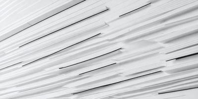 The primary subject of the image is a large white wall with a pattern of black stripes. The setting is a white room, and the visual style appears to be a combination of a photo and digital art. The dominant colors are white and black, creating a clean and modern atmosphere.