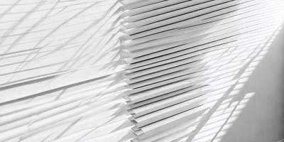 The primary subject of the image is a stack of white envelopes. The setting is a white background, which creates a clean and minimalist appearance. The visual style is a close-up of the envelopes, showcasing their texture and details. The colors and mood of the image are predominantly white, giving it a simple and elegant feel.
