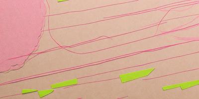 The primary subject of the image is a pink line on a brown surface. The setting is a table, and the visual style appears to be a combination of a photo and a drawing. The colors and mood of the image are predominantly pink and warm, creating a sense of creativity and playfulness.