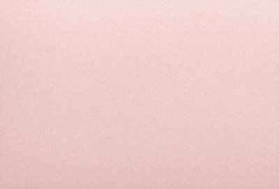 The primary subject of the image is a large sheet of pink paper. The setting is a blank, white wall, which serves as the background. The visual style is a close-up of the pink paper, showcasing its texture and color. The colors and mood of the image are predominantly pink, creating a warm and inviting atmosphere.