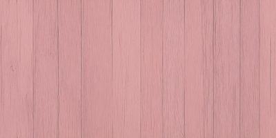 The primary subject of the image is a wooden wall with a pinkish hue. The setting is a room with a wooden floor, and the visual style is a close-up of the wooden wall. The colors and mood of the image are predominantly pink, creating a warm and inviting atmosphere.
