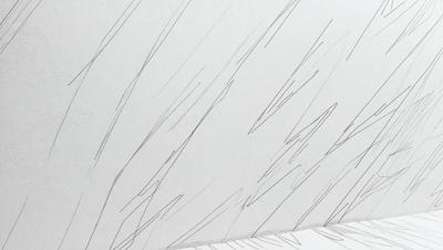 The primary subject of the image is a white sheet of paper with a drawing of a wall on it. The drawing appears to be a sketch of a wall with a few lines and shapes. The setting is a white background, and the visual style is a hand-drawn illustration. The colors and mood of the image are predominantly white, giving it a clean and minimalist appearance.