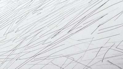 The primary subject of the image is a white sheet of paper with black lines drawn on it. The setting is a white background, and the visual style appears to be a drawing or a pattern. The black lines create a sense of depth and contrast against the white paper, giving the image a somewhat moody atmosphere.