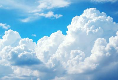 The primary subject of the image is a large, fluffy white cloud in the sky. The cloud is the main focus of the image, and it appears to be a natural, outdoor scene. The visual style of the image is a photo, capturing the cloud's beauty and texture. The cloud is the dominant feature in the image, and its presence creates a serene and peaceful atmosphere.