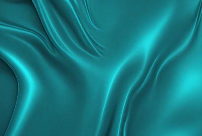 The primary subject of the image is a blue, flowing fabric that appears to be a piece of clothing or a curtain. The setting is a blue background, which complements the blue fabric. The visual style is a close-up of the fabric, showcasing its texture and flow. The colors and mood of the image are predominantly blue, creating a calm and serene atmosphere.