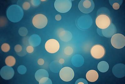 The primary subject of the image is a blue background with a pattern of white lights or circles. The setting appears to be a dark room, and the visual style is a combination of a photo and digital art. The dominant colors are blue and white, creating a calm and serene atmosphere.