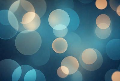 The primary subject of the image is a blue background with a pattern of white circles. The setting is a dark blue background, which contrasts with the white circles. The visual style is a digital art or illustration, as the circles are arranged in a visually appealing manner. The colors and mood of the image are predominantly dark and moody, with the white circles providing a touch of brightness and contrast.