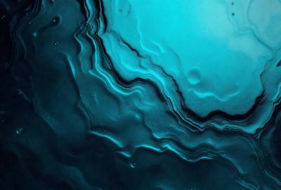 The primary subject of the image is a close-up of a blue, swirling, and wavy surface, possibly a piece of art or a photograph. The setting appears to be a dark, blue-toned environment, which adds to the overall mood of the image. The visual style of the image is a combination of a photo and a digital art piece, creating a unique and intriguing appearance. The dominant colors in the image are blue and black, which contribute to the overall atmosphere of the scene.