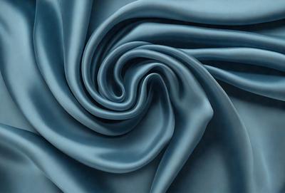 The primary subject of the image is a blue fabric, which is the main object, scene, or focus of the image. The setting/background consists of a blue cloth, and the visual style is a photo. The colors and mood of the image are predominantly blue, creating a calm and serene atmosphere.
