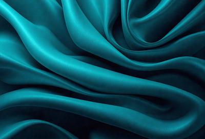 The primary subject of the image is a blue fabric, which is the main object, scene, or focus of the image. The setting or background is a blue cloth, and the visual style is a photo. The dominant colors and overall atmosphere are blue and purple, creating a serene and calming mood.