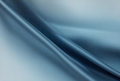 The primary subject of the image is a blue fabric, which appears to be a piece of cloth or a curtain. The setting is a room with a blue background, which creates a cohesive and visually appealing environment. The visual style of the image is a close-up of the blue fabric, showcasing its texture and details. The colors and mood of the image are predominantly blue, giving it a calm and serene atmosphere.