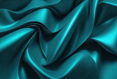 The primary subject of the image is a blue fabric, which appears to be a piece of silk. The setting is a dark background, which contrasts with the blue fabric. The visual style is a close-up of the fabric, showcasing its texture and pattern. The colors and mood of the image are predominantly blue, creating a calm and serene atmosphere.