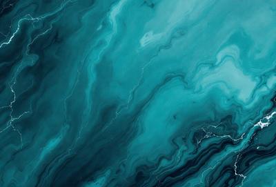 The primary subject of the image is a close-up of a blue and white ocean wave. The setting is the ocean, with the wave being the main focus of the image. The visual style is a photo of the ocean, capturing the beauty and power of the wave. The dominant colors are blue and white, creating a serene and calming atmosphere.
