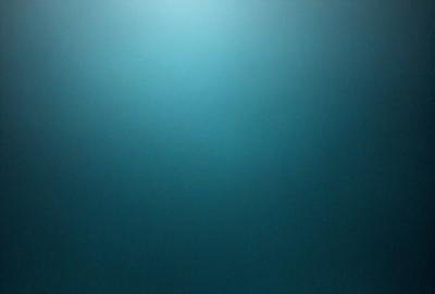 The primary subject of the image is a large, open, and dark blue sky. The setting is a vast, empty space with no visible landmarks or objects. The visual style is a natural, untouched, and unaltered representation of the sky. The colors and mood convey a sense of vastness, tranquility, and calmness.