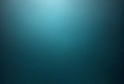 The primary subject of the image is a large, open, and dark blue sky. The setting is a vast, empty space with no visible landmarks or objects. The visual style is a natural, untouched, and unaltered representation of the sky. The colors and mood convey a sense of vastness, tranquility, and calmness.