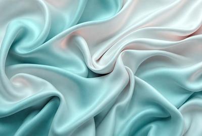 The primary subject of the image is a close-up of a blue fabric, possibly a piece of silk or satin. The setting is a room with a blue background, which adds to the overall atmosphere. The visual style is a close-up of the fabric, showcasing its texture and details. The colors and mood of the image are predominantly blue, creating a calm and serene atmosphere.