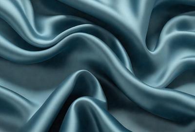 The primary subject of the image is a blue fabric, which is the main object, scene, or focus of the image. The setting or background is a blue cloth, and the visual style is a photo. The dominant colors and overall atmosphere are blue and serene.