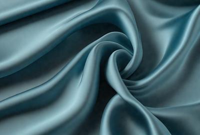 The primary subject of the image is a blue fabric, which appears to be a piece of cloth or a curtain. The setting is a room with a blue background, which complements the blue fabric. The visual style is a close-up of the fabric, showcasing its texture and details. The colors and mood of the image are predominantly blue, creating a calm and serene atmosphere.