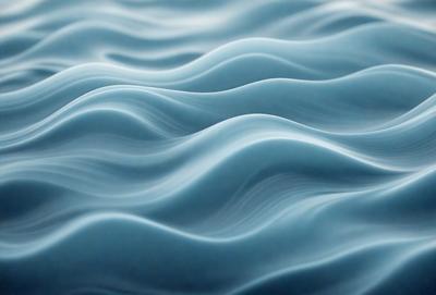 The primary subject of the image is a blue ocean with waves. The setting is the ocean, and the visual style is a photo. The dominant colors are blue and white, creating a calm and serene atmosphere.