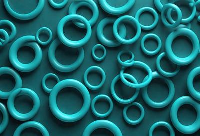 The primary subject of the image is a large number of blue rings or circles arranged in a pattern. The setting is a blue background, which creates a visually appealing contrast with the rings. The visual style is a combination of a photo and digital art, as the rings are arranged in a way that resembles a painting or a digital design. The dominant colors are blue, and the overall atmosphere is calm and serene.