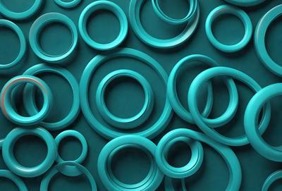 The primary subject of the image is a collection of blue rings, which are arranged in a visually appealing manner. The setting is a blue background, which complements the color of the rings. The visual style of the image is a close-up of the rings, showcasing their unique shapes and sizes. The dominant colors in the image are blue, which creates a calm and soothing atmosphere.