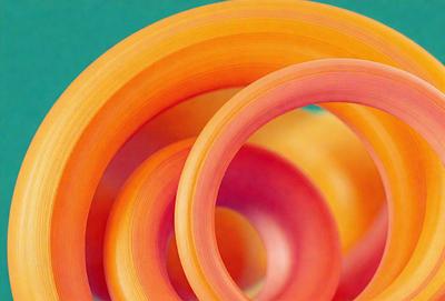 The primary subject of the image is a group of three orange and pink rings. These rings are arranged in a circular pattern, with one ring on the left, one in the middle, and one on the right. The setting is a green background, which provides a contrasting color to the rings. The visual style of the image is a close-up of the rings, showcasing their vibrant colors and unique patterns. The overall atmosphere of the image is lively and eye-catching, with the rings serving as the main