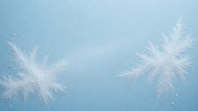 The primary subject of the image is a pair of snowflakes, which are the main objects in the scene. The snowflakes are floating in a blue sky, creating a serene and peaceful atmosphere. The visual style of the image is a photo, capturing the beauty of the snowflakes in their natural environment. The colors in the image are predominantly blue, which adds to the calming and tranquil mood of the scene.