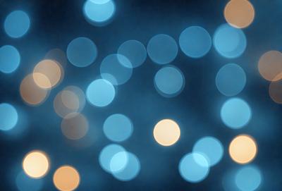 The primary subject of the image is a brightly lit, blue-toned background featuring a pattern of white lights. The setting appears to be a nighttime cityscape, with the lights creating a visually striking and lively atmosphere. The visual style of the image is a combination of photo and digital art, as it captures the vibrant colors and patterns of the lights. The overall mood of the image is energetic and captivating, with the lights creating a sense of movement and dynamism.