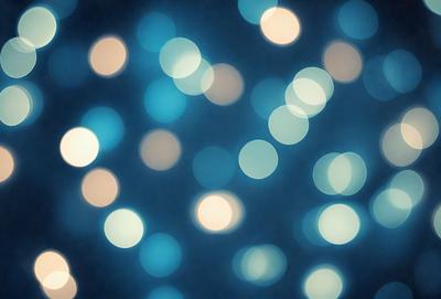 The primary subject of the image is a blue background with a pattern of white lights. The setting appears to be a nighttime scene, possibly a cityscape or a dark room with a light source. The visual style of the image is a combination of a photo and digital art, creating a unique and captivating atmosphere. The dominant colors are blue and white, with the white lights creating a sense of depth and contrast against the dark blue background.
