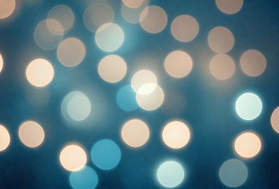 The primary subject of the image is a blue background with a large number of bright, white lights. The lights are scattered throughout the background, creating a visually striking and luminous scene. The visual style of the image is a combination of a photo and digital art, as the lights are arranged in a way that resembles a painting or digital illustration. The colors and mood of the image are predominantly blue and white, with the bright lights adding a sense of energy and dynamism to the scene.