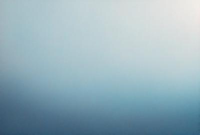 The primary subject of the image is a large, open, and cloudless sky. The setting is a vast, empty space with no visible landmarks or objects. The visual style is a natural, outdoor scene with a focus on the sky. The colors and mood are predominantly blue, creating a serene and peaceful atmosphere.
