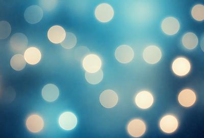 The primary subject of the image is a blue background with a pattern of white lights. The setting appears to be a dark room, and the visual style is a digital art or illustration. The dominant colors are blue and white, creating a calm and serene atmosphere.