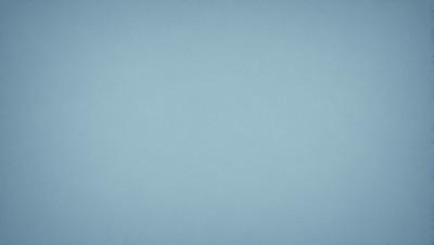 The primary subject of the image is a large, empty blue sky. The setting is a vast, open space with no visible landmarks or objects. The visual style is a natural, untouched landscape. The colors and mood are predominantly blue, creating a calm and serene atmosphere.