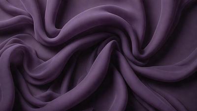 The primary subject of the image is a purple fabric, which is the main object, scene, or focus of the image. The setting or background is a dark purple surface, and the visual style appears to be a photo. The colors and mood of the image are predominantly purple, creating a calm and serene atmosphere.
