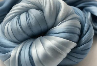 The primary subject of the image is a large, blue, and white ball of yarn. The setting is a white surface, and the visual style appears to be a close-up of the yarn. The colors and mood of the image are predominantly blue and white, giving it a calm and serene atmosphere.