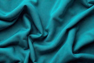 The primary subject of the image is a blue fabric, which is the main object, scene, or focus of the image. The setting or background is a blue cloth, and the visual style is a photo. The dominant colors and overall atmosphere are blue and purple, creating a calm and serene mood.