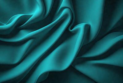 The primary subject of the image is a blue fabric, which appears to be a piece of silk. The setting is a dark background, which contrasts with the vibrant blue fabric. The visual style is a close-up of the fabric, showcasing its texture and pattern. The colors and mood of the image are predominantly blue, creating a calm and serene atmosphere.