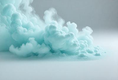 The primary subject of the image is a large, swirling mass of blue smoke or foam, which appears to be floating or billowing in the air. The setting is a white background, which provides a clean and uncluttered environment for the smoke or foam to be the main focus. The visual style of the image is a combination of photo and digital art, as it captures the movement and texture of the smoke or foam in a realistic yet artistic manner. The dominant colors in the image are blue and