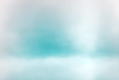 The primary subject of the image is a cloudy blue sky. The setting is a vast, open space with no visible landmarks or objects. The visual style is a natural, outdoor scene. The dominant colors are blue and gray, creating a calm and serene atmosphere.