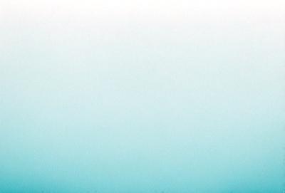 The primary subject of the image is a large, empty, and blue sky. The setting is a vast, open space with no visible landmarks or objects. The visual style is a natural, outdoor scene with a serene and peaceful atmosphere. The colors and mood are predominantly blue, creating a calm and tranquil environment.