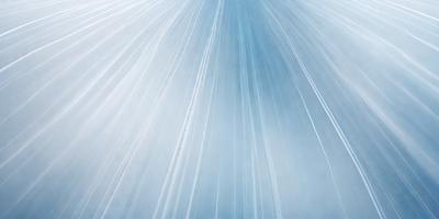 The primary subject of the image is a blue sky with white streaks, creating a visually striking scene. The setting is a cloudy sky, and the visual style appears to be a photo. The colors and mood of the image are predominantly blue and white, with a sense of depth and movement.