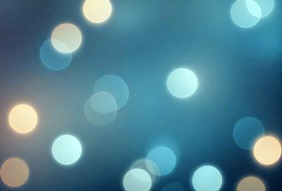 The primary subject of the image is a blue background with a pattern of white lights. The setting appears to be a dark room, and the visual style is a combination of a photo and digital art. The dominant colors are blue and white, creating a calm and serene atmosphere.