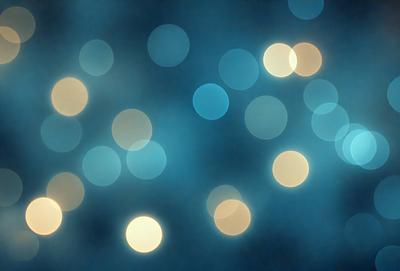 The primary subject of the image is a blue background with a pattern of white lights. The setting appears to be a dark room, and the visual style is a combination of a photo and digital art. The dominant colors are blue and white, creating a calm and serene atmosphere.
